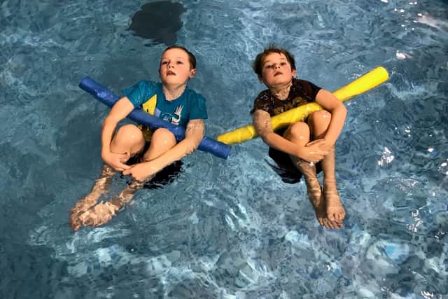Little swimmers take part in a pajama class with Puddle Ducks. 