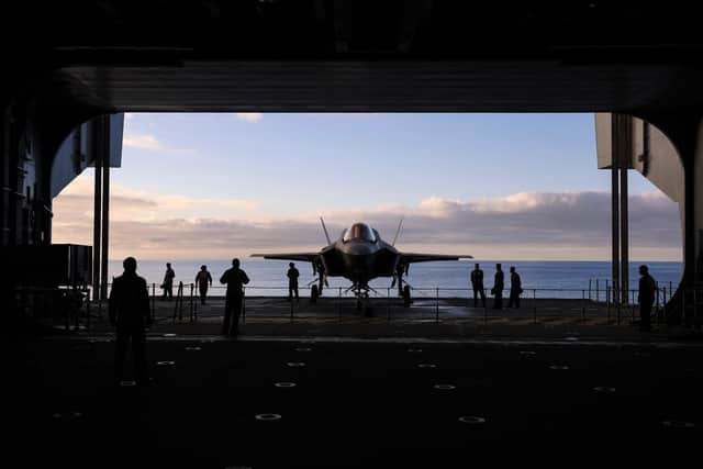 Pictured: F35 Jet is placed on the lift by the hanger party in preparation for launch.