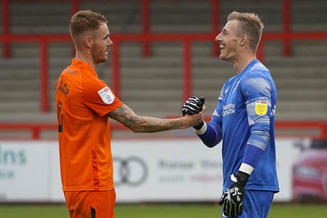 Skipper Tom Naylor congratulations Craig MacGillivray following the goalkeeper's penalty heroics against Stevenage on Saturday. Picture: Jason Brown/ProSportsImages
