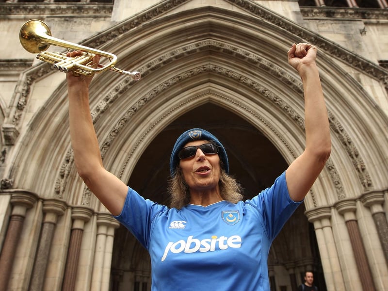 Jo Collins holds her trumpet as she celebrates outside The High Court in August 2010. Photo by Peter Macdiarmid/Getty Images