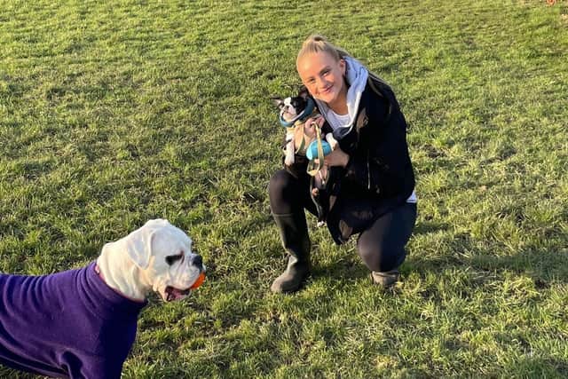 Evie Gane has found peace since her October 2022 breakdown and loves walking her dogs. Pictured cradling Riley and also joined by Dotty.