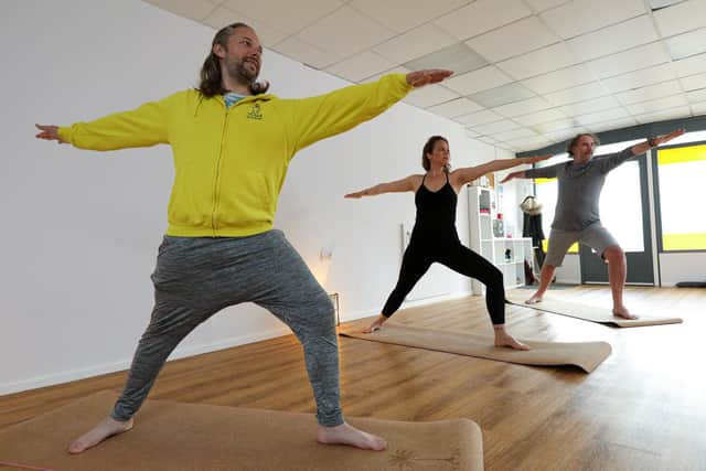Luke Voulgarakis, in yellow, has reopened his yoga studio, LV Yoga, in West St, Fareham, now that Covid-19 restrictions are easing. He is pictured with fellow yoga teachers Victoria Beale and Warren Bright
Picture: Chris Moorhouse (jpns 160521-08)