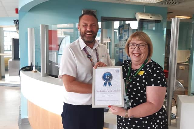 Matt McLean receiving an award from Kim Barnes, Estates Locality Manager, for 25 years at St Mary's Hospital in Portsmouth.