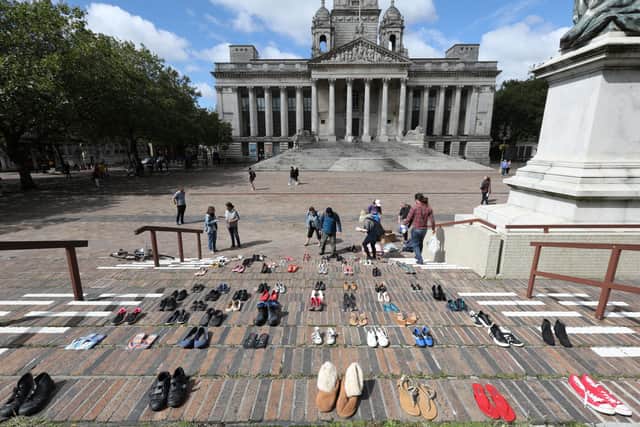 Extinction Rebellion supporters place 95 pairs of shoes on the steps of the Civic Offices in Portsmouth, one pair per life lost due to air pollution in the city each year 
Picture: Chris Moorhouse   (290820-01)