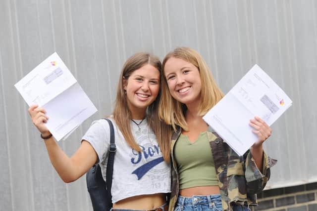 Two Portsmouth College students with their results in 2019. Picture: Sarah Standing (150819-5484)