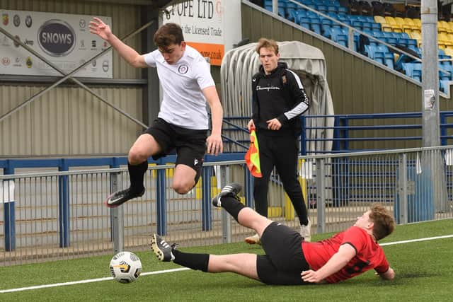 An East Lodge player leaps over a Horndean United challenge. Picture: Keith Woodland