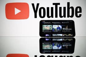 A picture taken on October 5, 2021 in Toulouse shows the logo of Youtube social media displayed by a screen and its website displayed by tablet. ) (Photo by LIONEL BONAVENTURE/AFP via Getty Images)