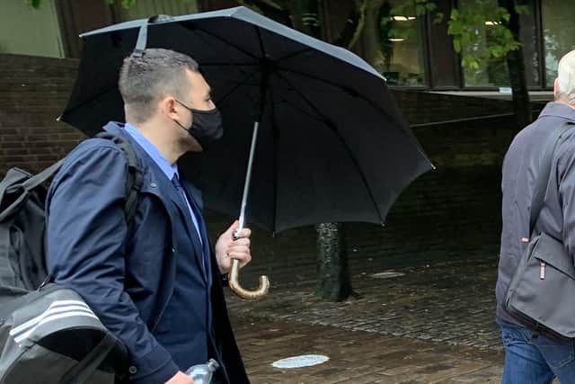 Former PCSO Joshua Fitzjohn leaves Portsmouth Crown Court holding an umbrella having been sentenced for coercive control of his wife.