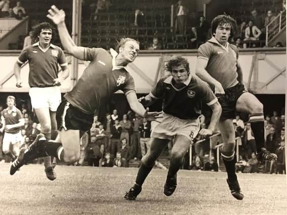 Dave Kemp, centre, gets in-between two defenders to threaten on goal for Pompey
