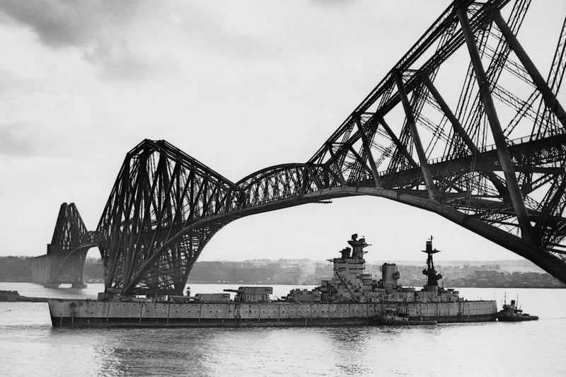 The Royal Navy Nelson-class battleship HMS Nelson, named in honour of Horatio Nelson, 1st Viscount Nelson the victor at the Battle of Trafalgar, passes under the Forth Bridge on her way to the Thomas W Ward shipyard for scrapping in Inverkeithing on 16 March 1949 in the Firth of Forth, Scotland, United Kingdom. (Photo by Keystone/Hulton Archive/Getty Images).