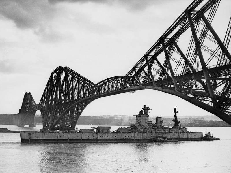 The Royal Navy Nelson-class battleship HMS Nelson, named in honour of Horatio Nelson, 1st Viscount Nelson the victor at the Battle of Trafalgar, passes under the Forth Bridge on her way to the Thomas W Ward shipyard for scrapping in Inverkeithing on 16 March 1949 in the Firth of Forth, Scotland, United Kingdom. (Photo by Keystone/Hulton Archive/Getty Images).