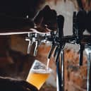 Beer being poured into glasses at a pub. PIC: Adobe