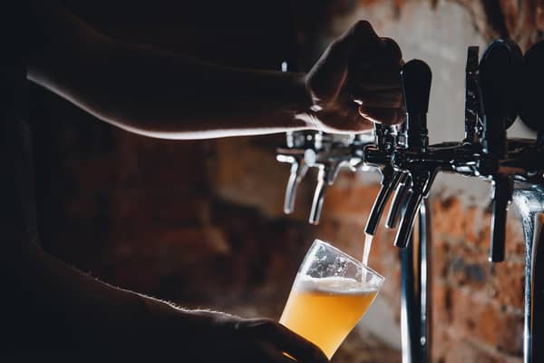 Beer being poured into glasses at a pub. PIC: Adobe