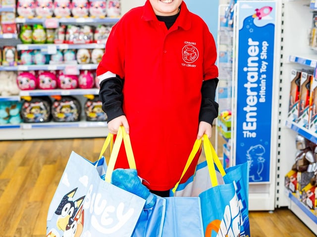 Beau from Connor's Toy Library with 2 bags of toys worth £199