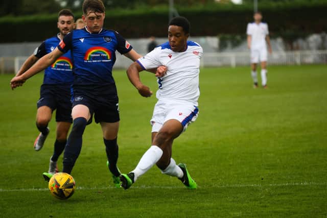 Gosport sub Jordan Ragguette, right, looks to put in a tackle during his side's loss at Met Police. Pic: Tom Phillips.
