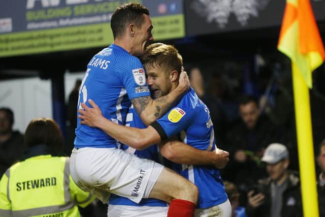 Michael Jacobs is mobbed by his team-mates after his equaliser against AFC Wimbledon