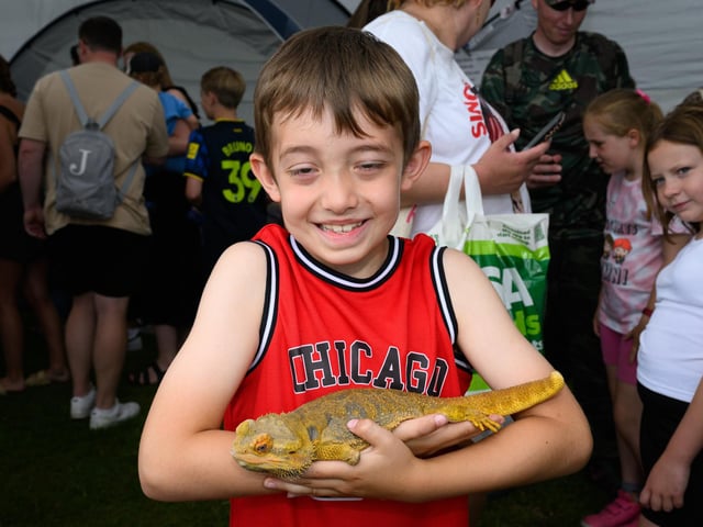 Pictured is: Theo Singleton and Bearded Dragon called 'Scuttle' who has only one leg.Picture: Keith Woodland (230621-65)