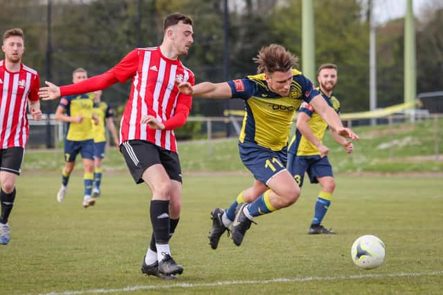 Joe Briggs is brought down on the edge of the box, leading to protests from Moneyfields players that a red card should have been shown. Picture: Paul Collins
