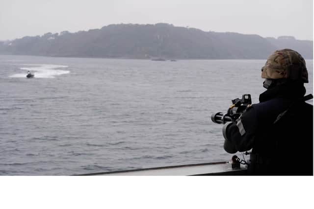 A sailor from HMS Dragon prepares to defend against attack from a fast boat during a drill with French authorities. Photo: Royal Navy