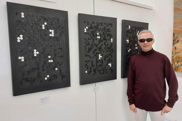 Clarke Reynolds with his Absurd Cryptic Triptych at The Unhooked exhibition at Yellow Edge Gallery in Gosport