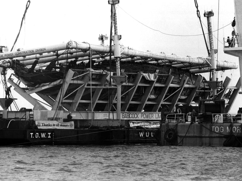 The Mary Rose in its cradle being brought ashore by a barge in October 1982. The News PP3741