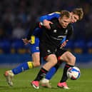 Anthony Scully, pictured battling against AFC Wimbledon's Daniel Csoka, is one of five Pompey signings since the transfer window opened. Picture: Justin Setterfield/Getty Images.