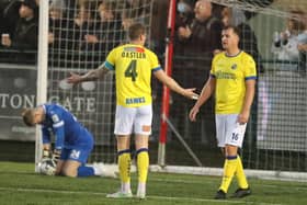 Hawks captain Joe Oastler, left, is unimpressed as Hawks concede again in their 8-0 Boxing Day defeat at Dorking Wanderers. Picture: Dave Haines