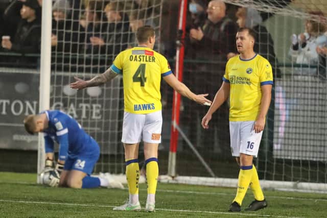 Hawks captain Joe Oastler, left, is unimpressed as Hawks concede again in their 8-0 Boxing Day defeat at Dorking Wanderers. Picture: Dave Haines