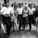 Workers at the Metal Box factory, Copnor, wasted no time in introducing Russian guests from the Obraztsovy to an English knees-up, 1976. Picture: The News PP5040