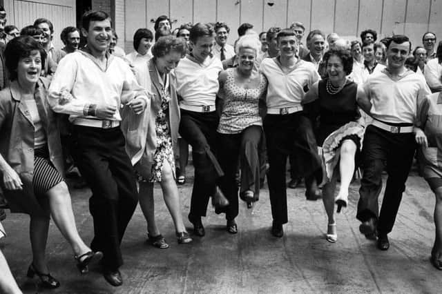 Workers at the Metal Box factory, Copnor, wasted no time in introducing Russian guests from the Obraztsovy to an English knees-up, 1976. Picture: The News PP5040
