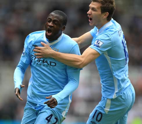 Former Pompey targets Yaya Toure and Edin Dzeko celebrate scoring for Manchester City. Picture: Mike Egerton