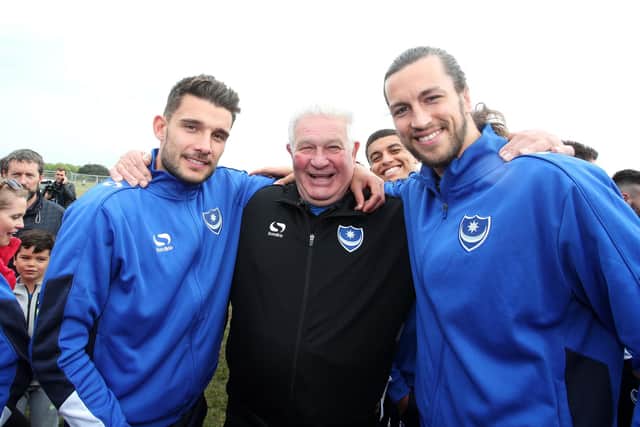 Barry Harris is flanked by Pompey favourites Gareth Evans and Christian Burgess at the League Two title-winning celebrations on Southsea Common. Picture: Joe Pepler