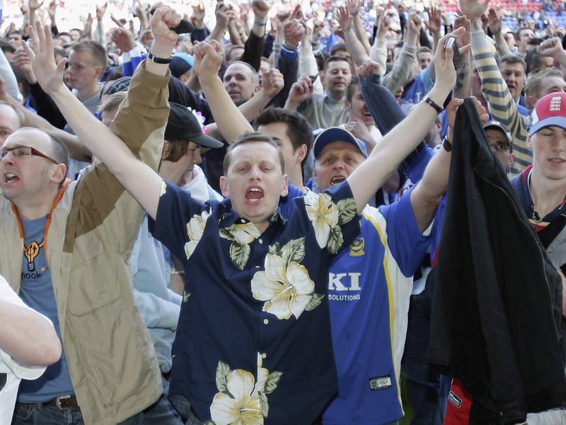 Pompey fans celebrate escaping Premier League relegation at Wigan in April 2006. Photo by Ross Kinnaird/Getty Images