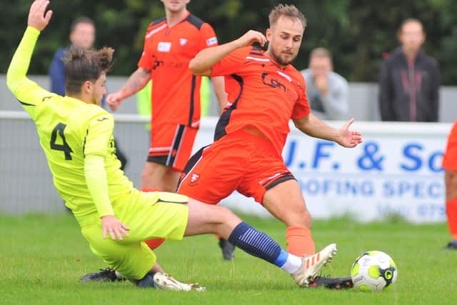Horndean's Sam Hookey, left, slides in to tackle George Colson. Picture: Martyn White