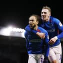 Marcus Harness celebrates with Ronan Curtis as Pompey registered a ninth consecutive Fratton Park triumph on Tuesday night. Picture: Joe Pepler