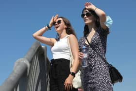 Two walkers look to the sea during the weekend's hot weather in Old Portsmouth.