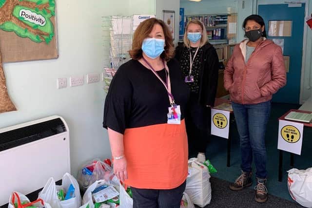 Stephanie Hall (left), family liaison at Milton Park Primary School, accepting food parcels from the University of Portsmouth.
