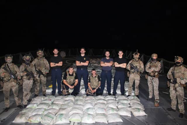 Lancaster's sailors and Royal Marines pose with the haul of hashish:HMS Lancaster sailors and Royal Marines pictured alongside the haul of hashish. Picture: Royal Navy