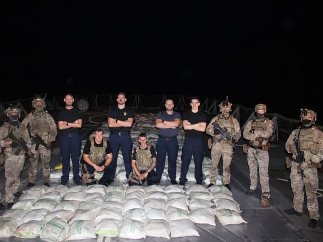 Lancaster's sailors and Royal Marines pose with the haul of hashish:HMS Lancaster sailors and Royal Marines pictured alongside the haul of hashish. Picture: Royal Navy