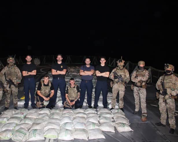Lancaster's sailors and Royal Marines pose with the haul of hashish:HMS Lancaster sailors and Royal Marines pictured alongside the haul of hashish. Picture: Royal Navy