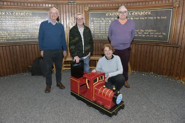 Portsea Men's Shed have been making toy trains and have donated one of them to St Luke's Church in Somerstown, for their Tots in Tow free stay and play group on Tuesday's. Pictured is: (back l-r) From Portsea Men's Shed Andy Pottinger, chairman and train builders Garry Shipp, Michael Weyman with Annie McCabe, vicar at St Luke's Church.Picture: Sarah Standing (130223-9372)