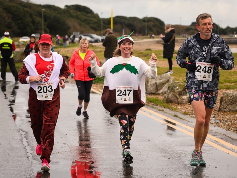 Three runners approach the finish line at the Christmas Pud 5k, Stokes Bay, Gosport