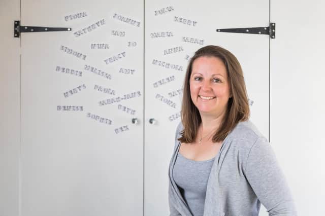 Sarah-Jane Lewis in her treatment room, with the names of some of the clients that she has assisted. Picture: Mike Cooter (100521)