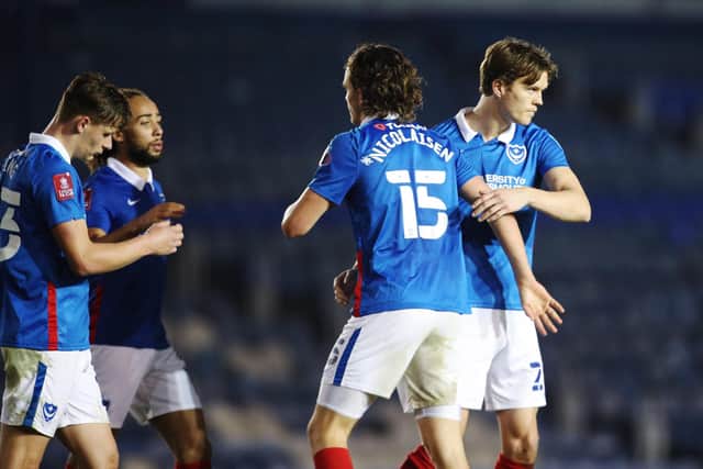 Goalscorers and centre-half partners Rasmus Nicolaisen at the final whistle after Pompey's 6-1 win over King's Lynn. Picture: Joe Pepler