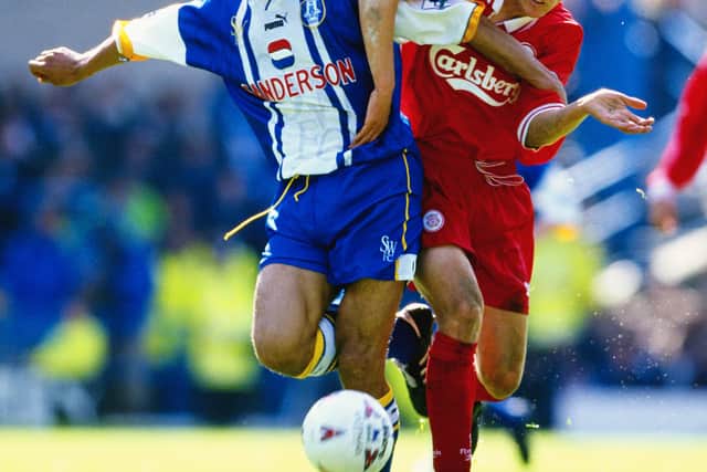 Sheffield Wednesday defender Des Walker, father of Tyler, challenges Liverpool's Michael Owen in a Premier League match in May 1997. Picture: Mark Thompson/Allsport/Getty Images