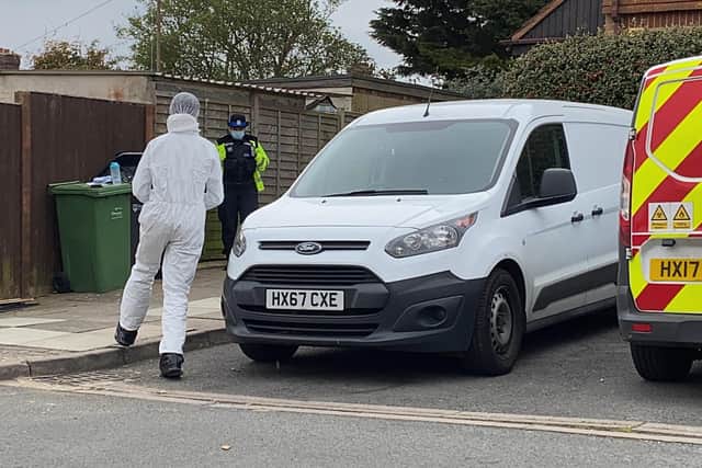 A forensic officer pictured heading into the garden where the injured man was found in Paulsgrove. Photo: Tom Cotterill