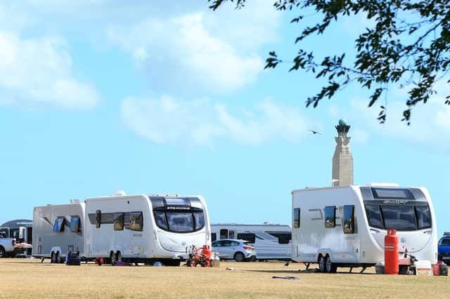 Travellers on Southsea Common  with the Royal Naval memorial, behind