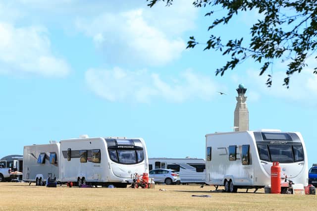 Travellers on Southsea Common with the Royal Naval memorial, behind