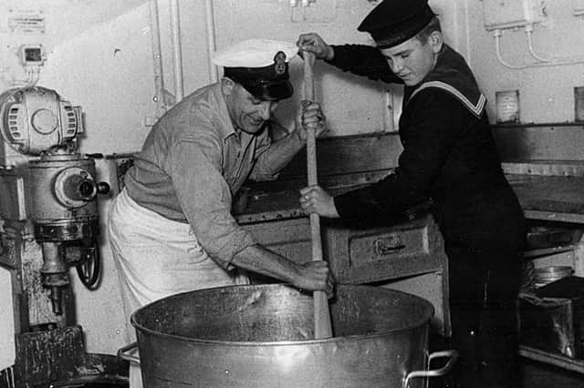 Maureen Maidment sent in this photograph of her father and the youngest member of the crew, Jerry Locke from Portchester, stirring the Christmas  pudding with a paddle. It was taken aboard HMS Maidstone, a submarine depot ship, in  December 1954.