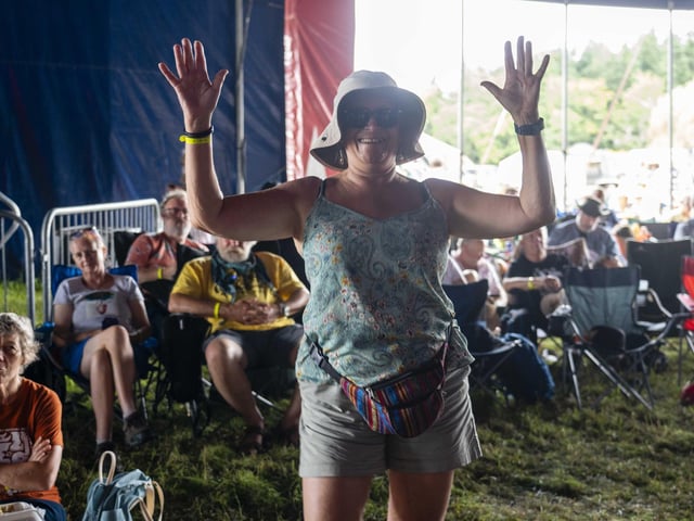Hands up if you are having fun! Festival-goer enjoying their time at Wickham Festival